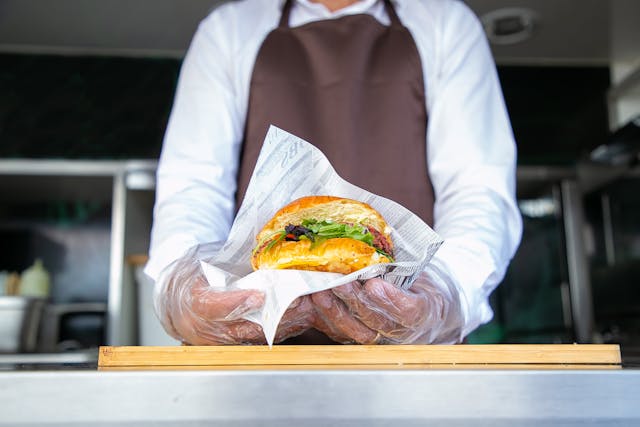 Chef holding a wrapped sandwich